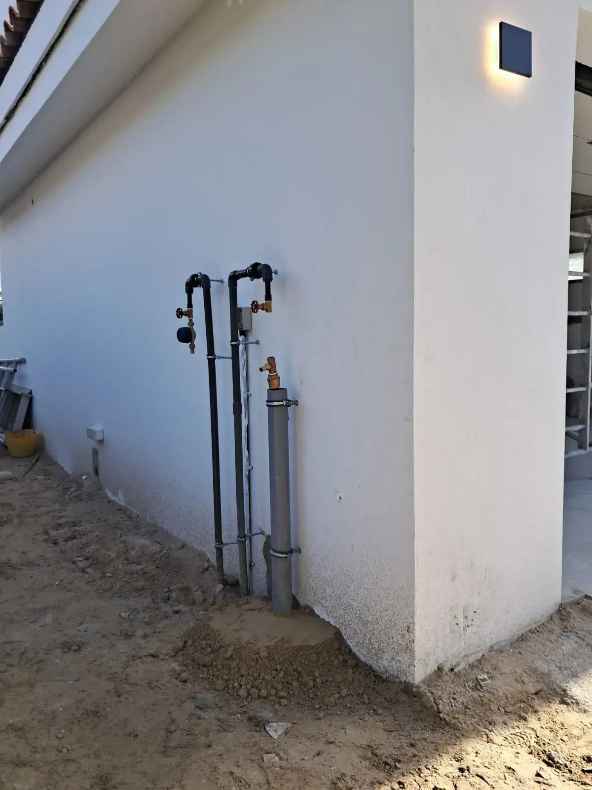Water supply risers along an exterior wall
